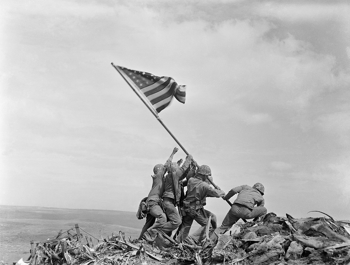 Six U.S. Marines raise the American flag on top of Mt. Suribachi, Iwo Jima, 23 February, 1945.